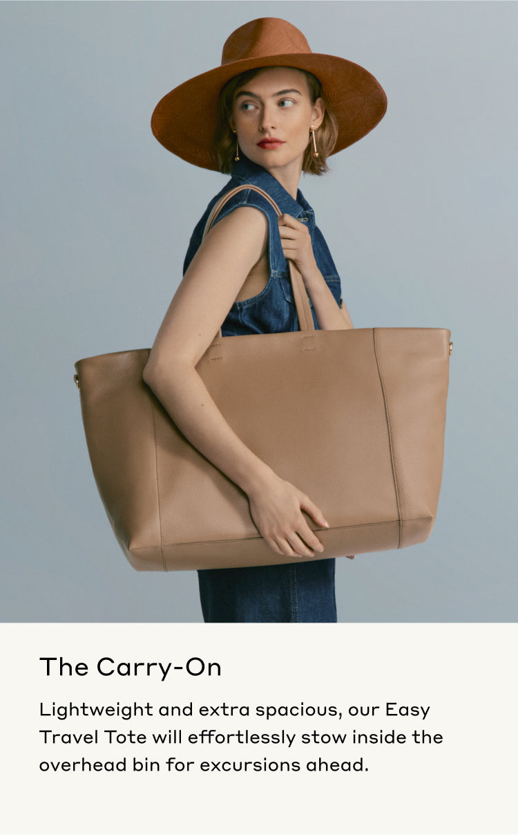 Woman wearing a hat and sleeveless top holding a large tote bag.