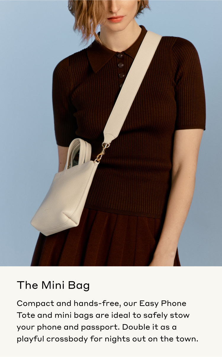 Woman wearing a dress and carrying a crossbody bag.