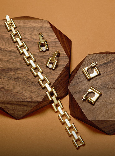 Jewelry set with bracelet and earrings on geometric wooden boards