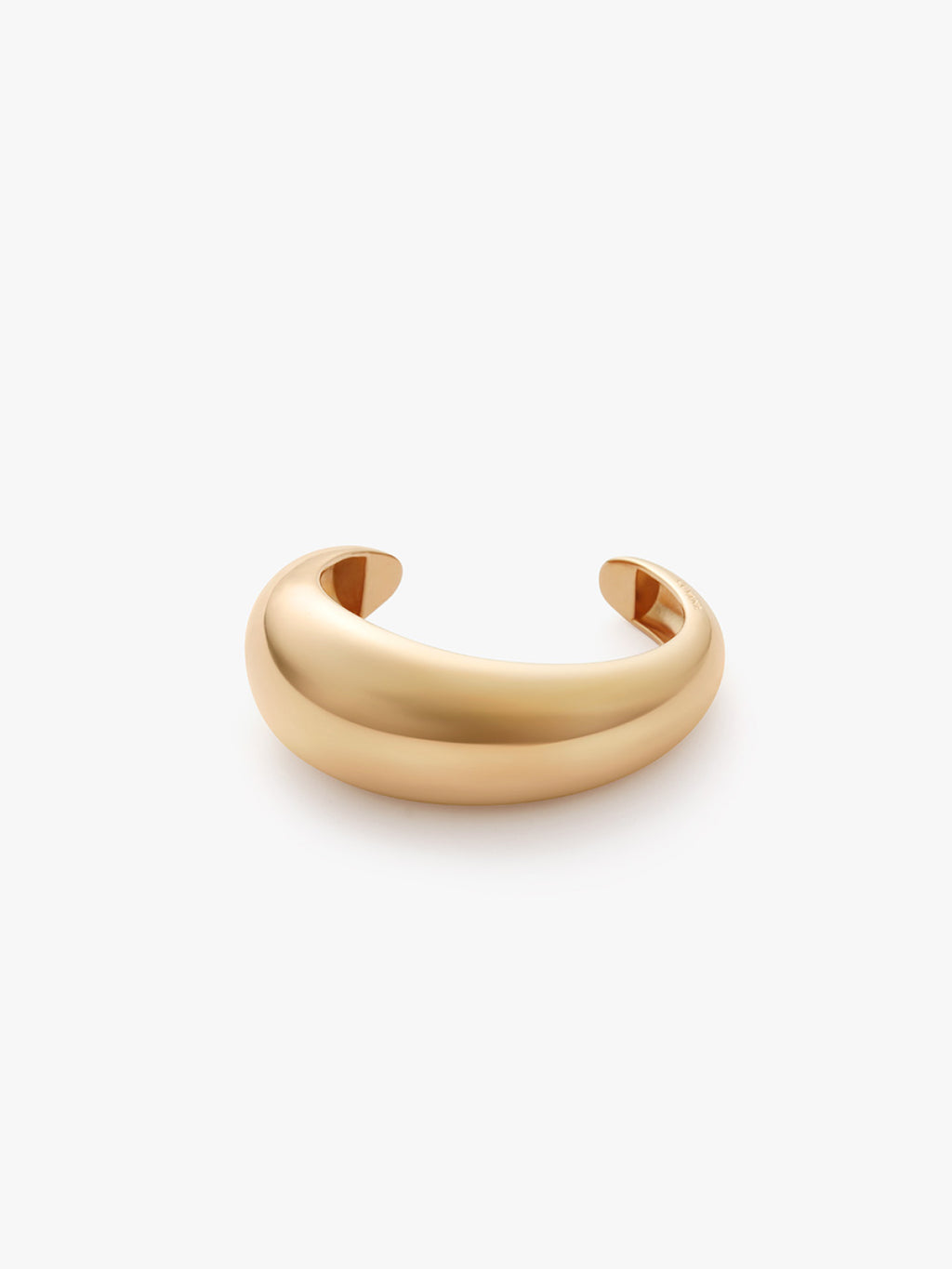 Smooth, thick bangle bracelet on a plain background