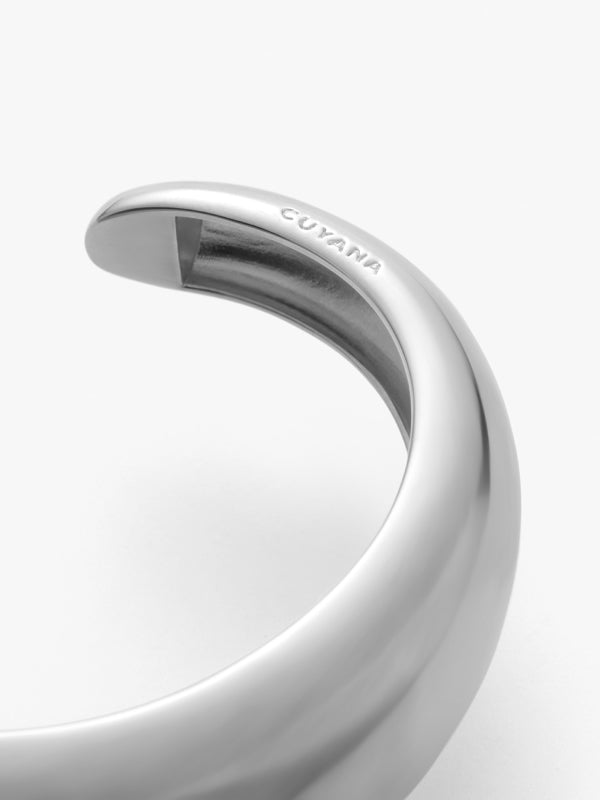 Close-up view of a curved metal object with text engraved on it.