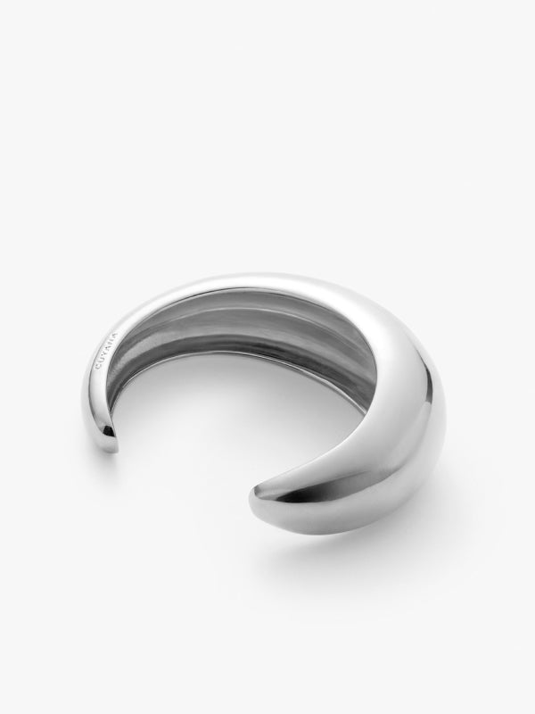Open-ended metallic bracelet on a plain background.