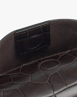 Open belt bag with croc-embossed leather texture and magnetic clasp.
