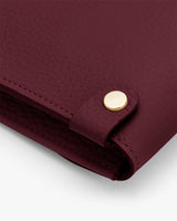 Close-up of a textured leather surface with a metallic button