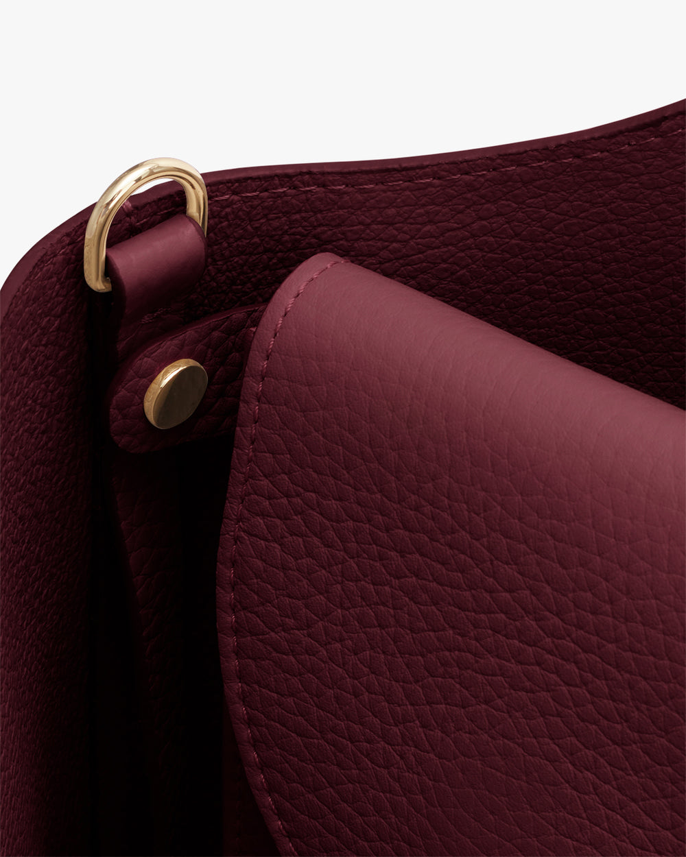 Close-up of textured handbag with gold hardware.