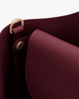 Close-up of textured handbag with gold hardware.