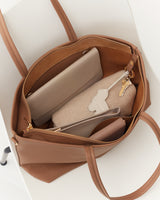 Open tote bag with a wallet, pouch, and keys inside.