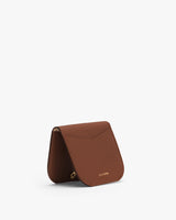 Small leather handbag with flap closure.