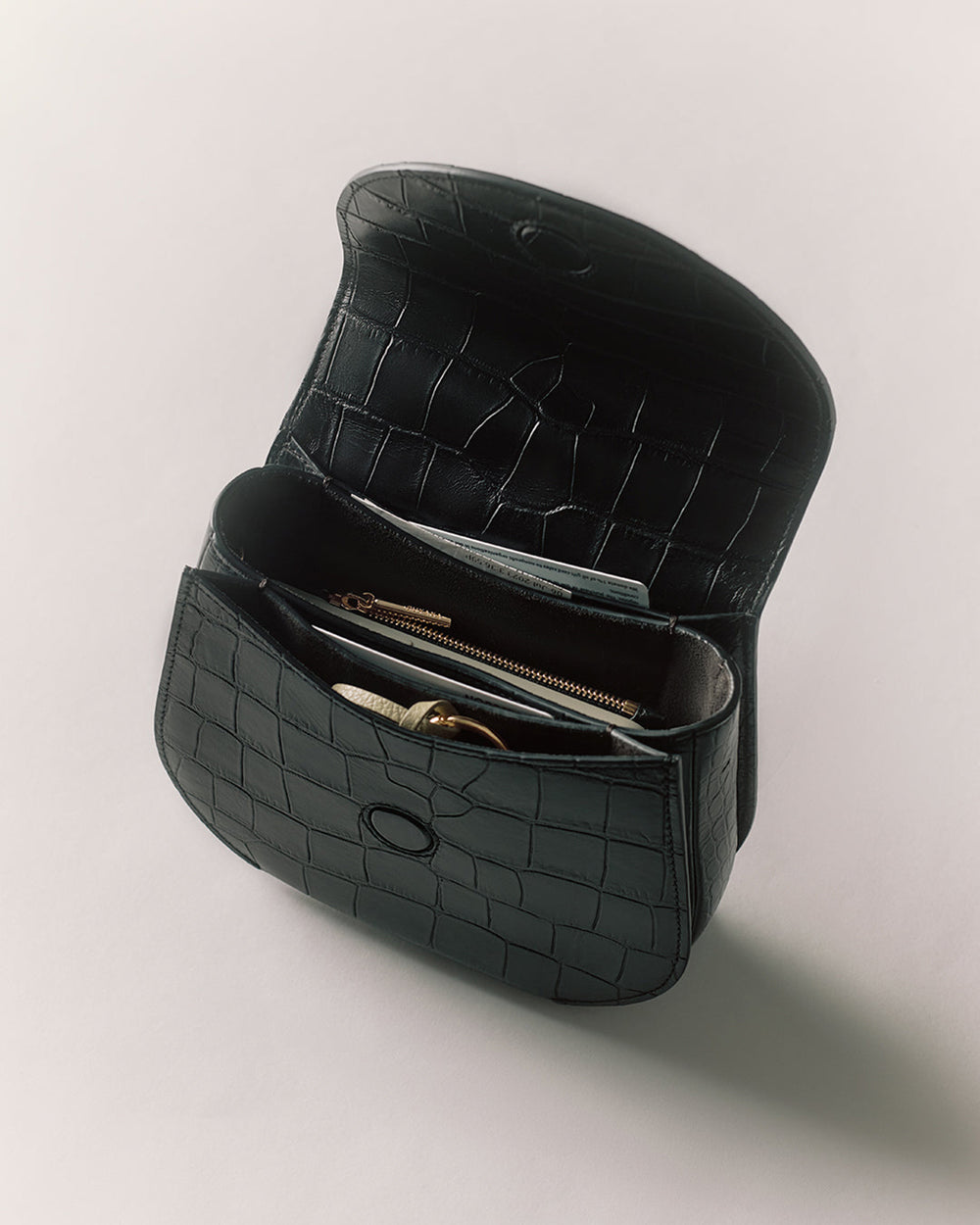 Open handbag with croc-embossed leather and visible interior pockets.
