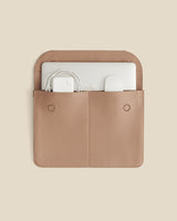Laptop sleeve with two pockets holding a laptop and cables
