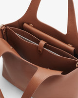 Open tote bag with interior compartments and top handles.