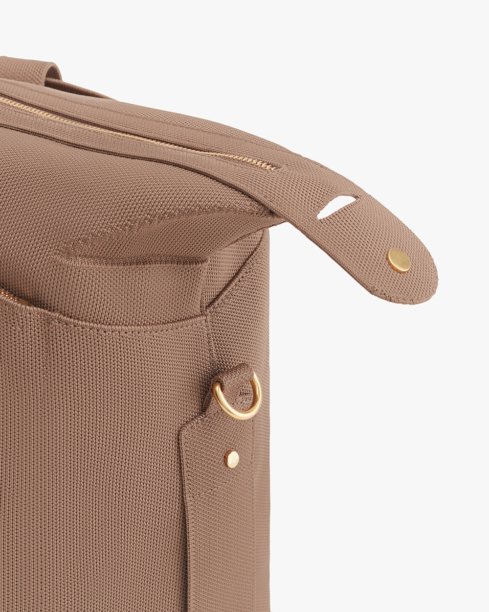 Close-up of a travel bag corner with zipper and button details.