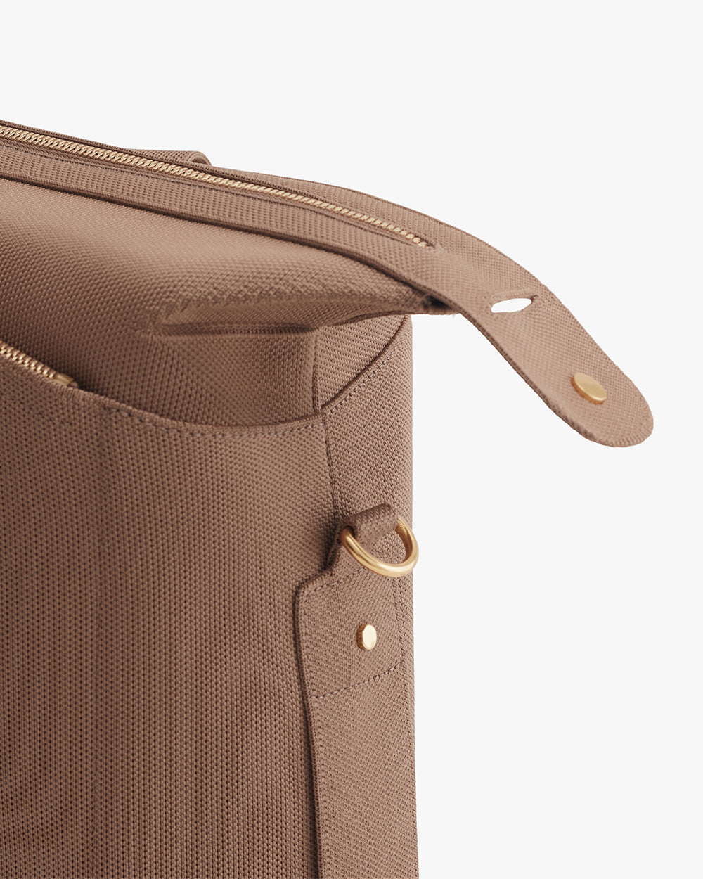 Close-up of a travel bag with zipper and metal ring detail.