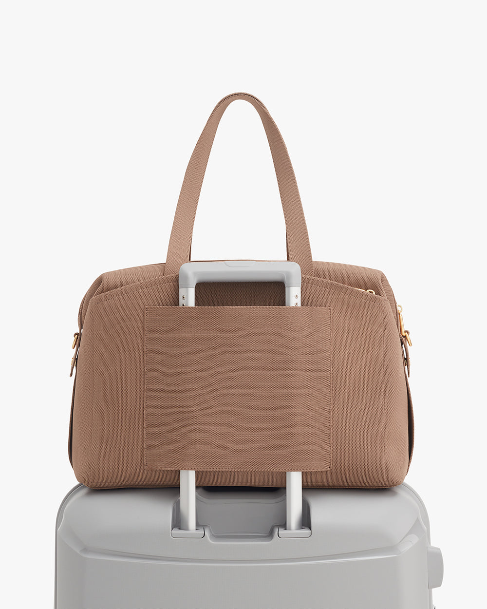 Travel bag on suitcase handle with side pocket facing front