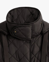 Close-up of a quilted jacket with a high collar and button details.