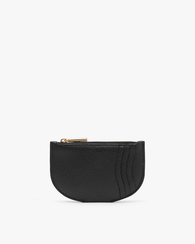 Textured coin purse with zipper on plain background.