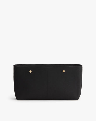 Rectangular bag with a flat bottom and two visible studs on front.