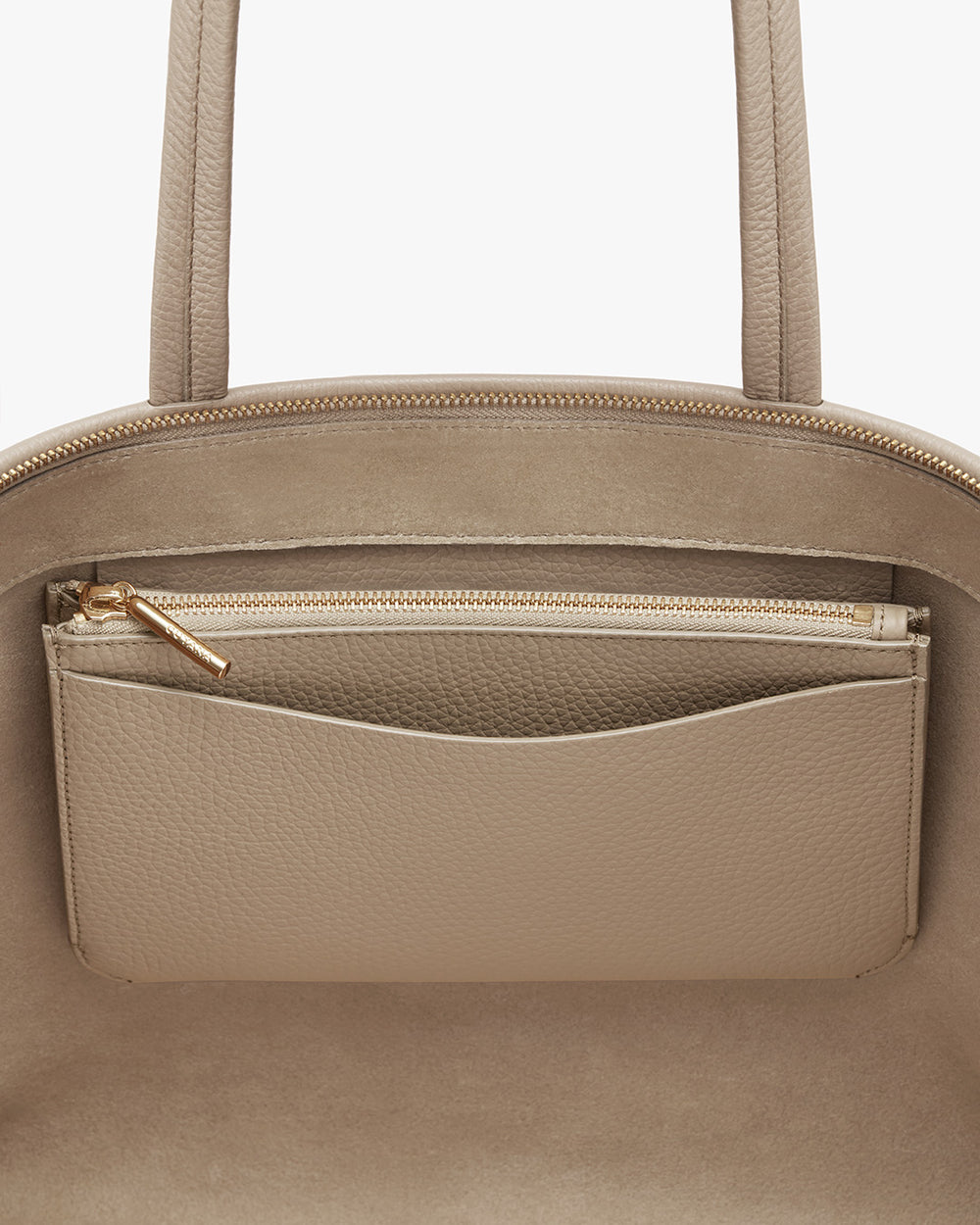 Close-up of a handbag with a zipper pocket on the exterior.