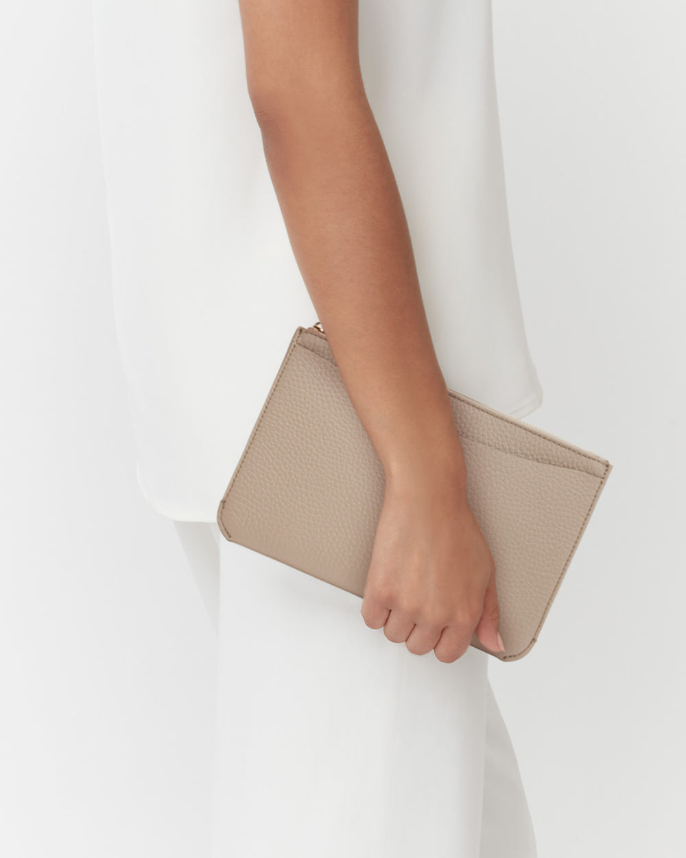 Person holding a small clutch bag