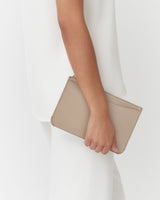 Person holding a small clutch bag