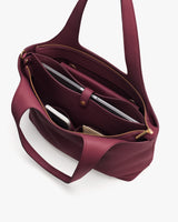 Open travel bag with laptop and other items inside