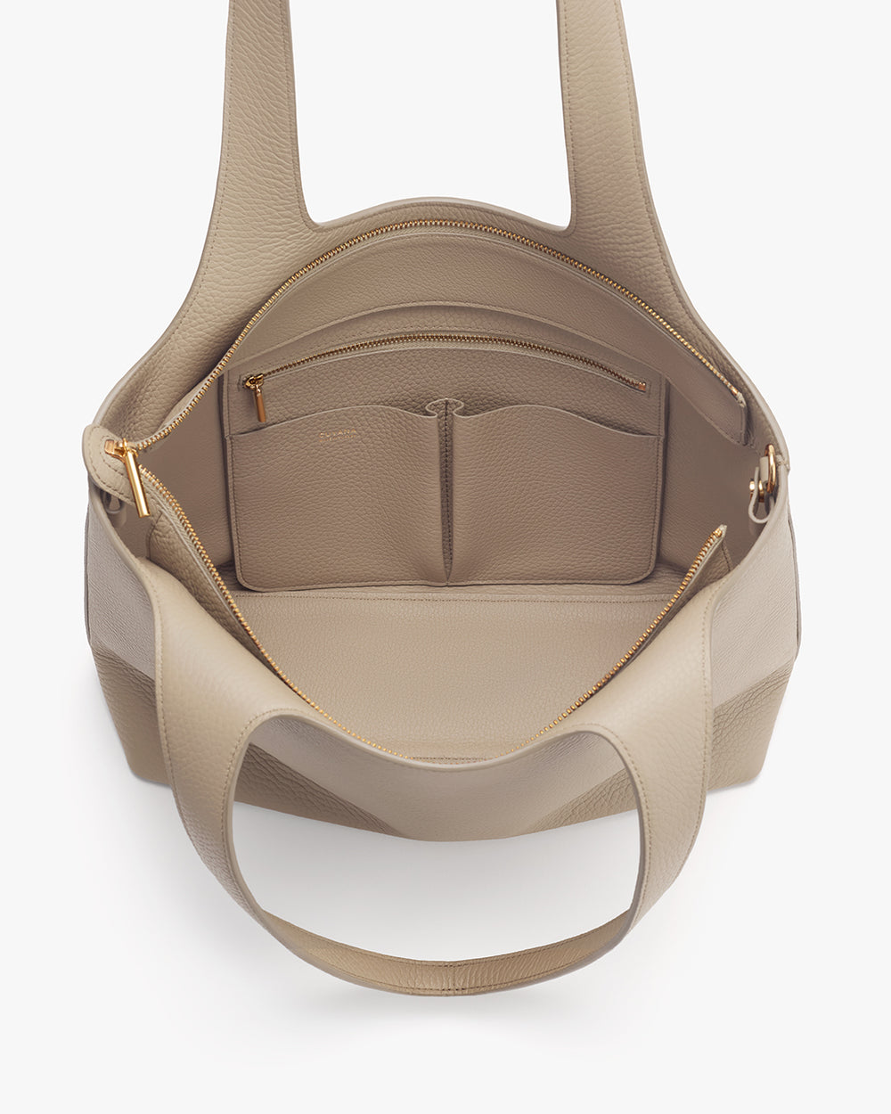 Open travel bag showing interior pockets and top zipper.