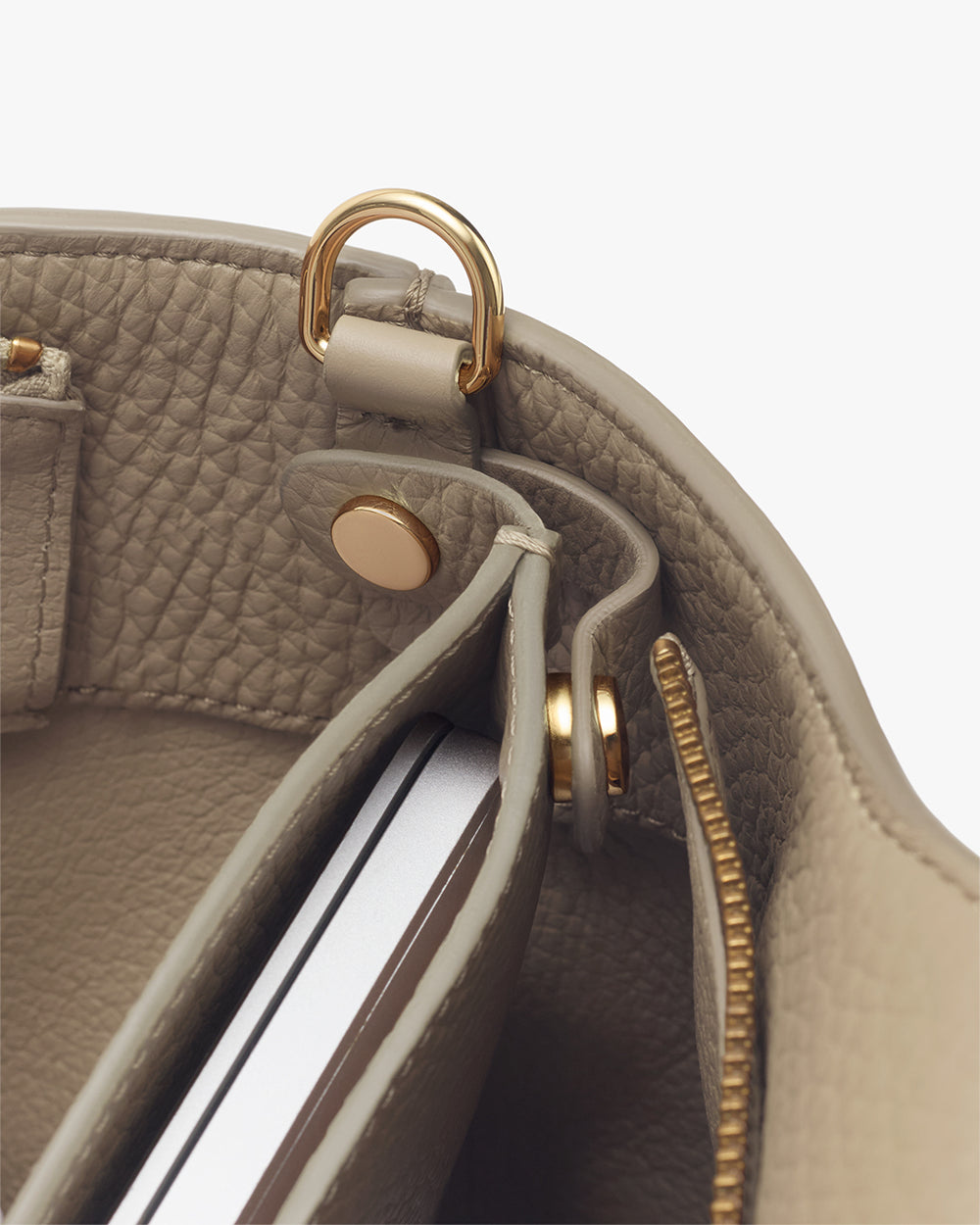 Interior view of a bag showing a pocket and a metallic ring attachment