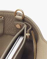 Interior view of a bag showing a pocket and a metallic ring attachment