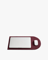Laptop and mouse on a flattened laptop sleeve.