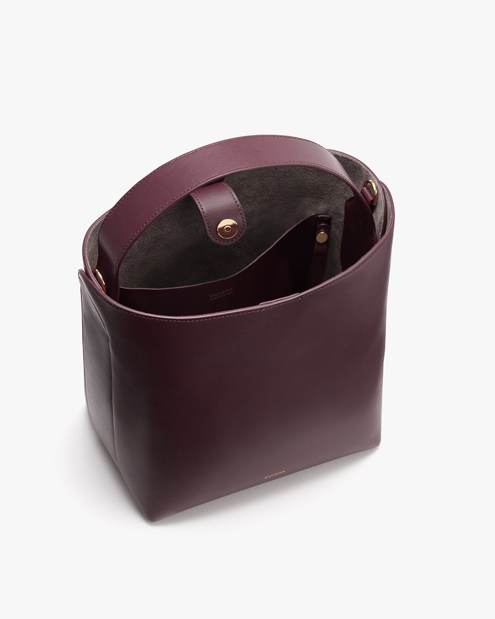 Open rectangular leather handbag with a top handle and visible interior.