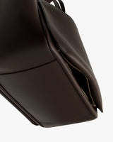 Close-up of a tote bag with a partially open zipper.
