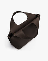 Handbag with curved handle and detachable strap