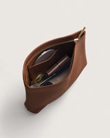 Open pouch with sunglasses, compact, and other small items inside