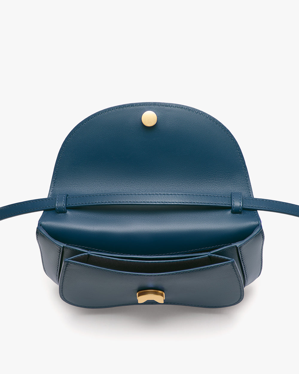 Open handbag with flap and button clasp, showing interior.