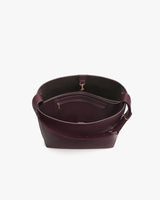 Open handbag with visible interior pockets and strap.