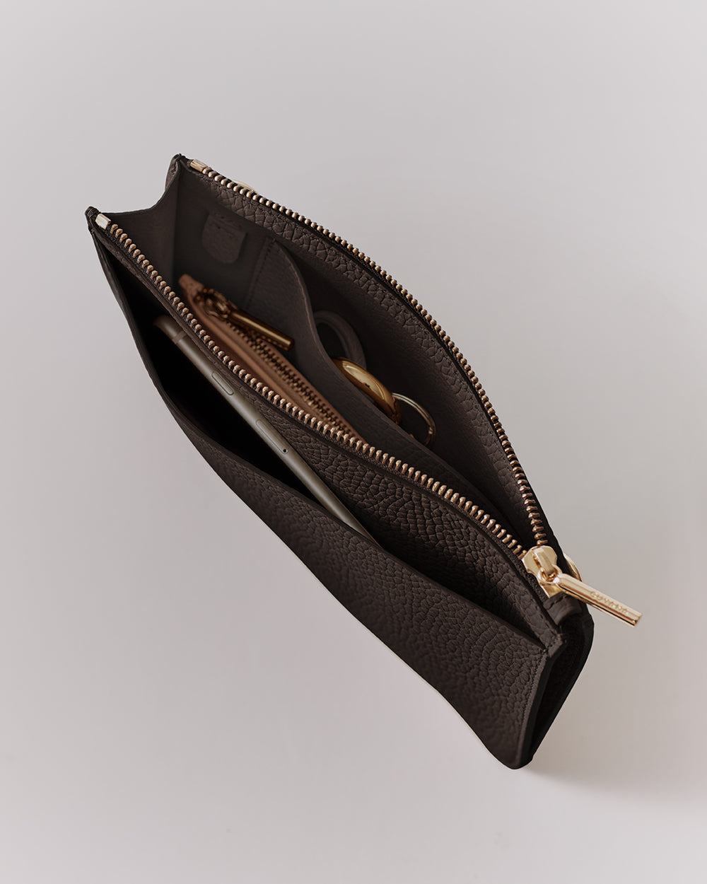 Open pouch with zipper, containing keys and a smartphone.