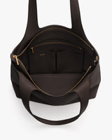 Open tote bag with pockets and zippers visible inside.