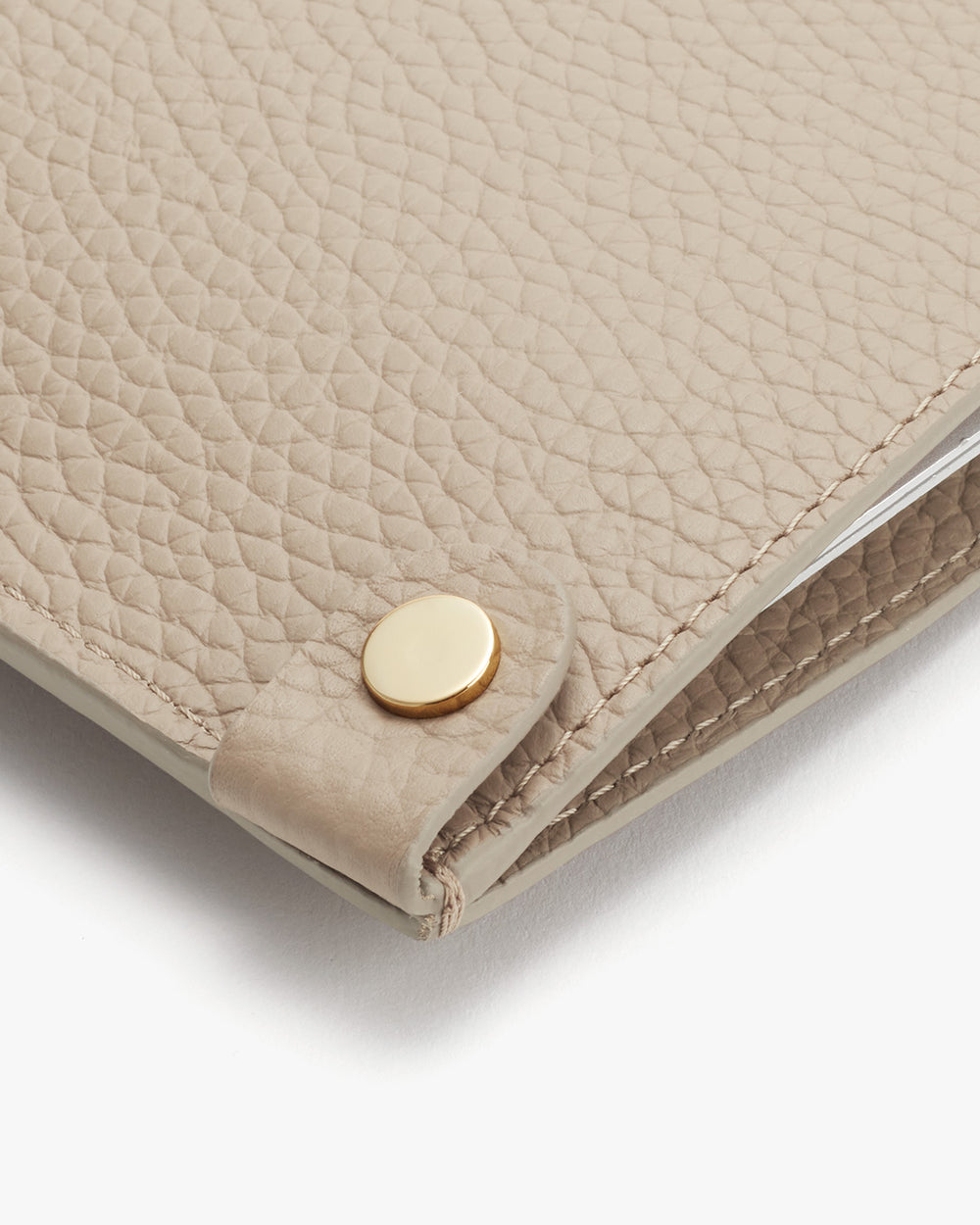 Close-up of a textured wallet with a snap closure.