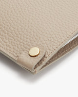 Close-up of a textured clutch with a metallic clasp