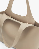 Close-up of a structured tote bag with two handles.