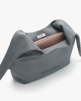 Open shoulder bag with a zipper and branded text.