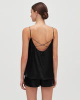 Woman seen from behind wearing a camisole with crossed straps.