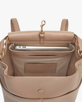 Open backpack showing interior with a laptop and small pocket.