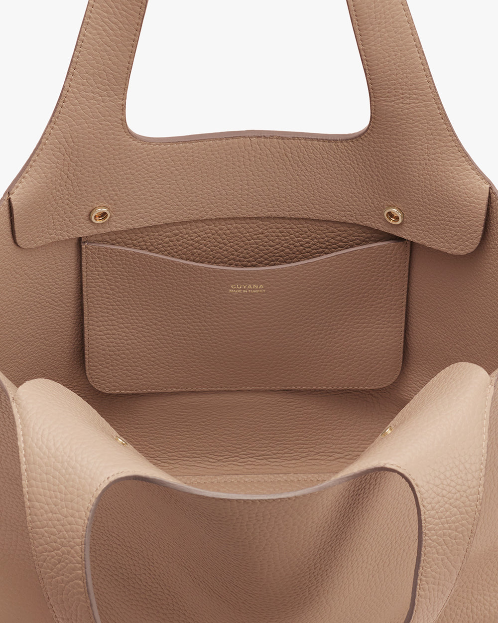Close-up view of an open handbag with a visible inner pocket.