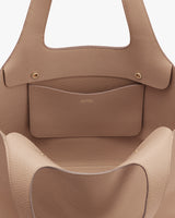 Close-up view of an open handbag with a visible inner pocket.