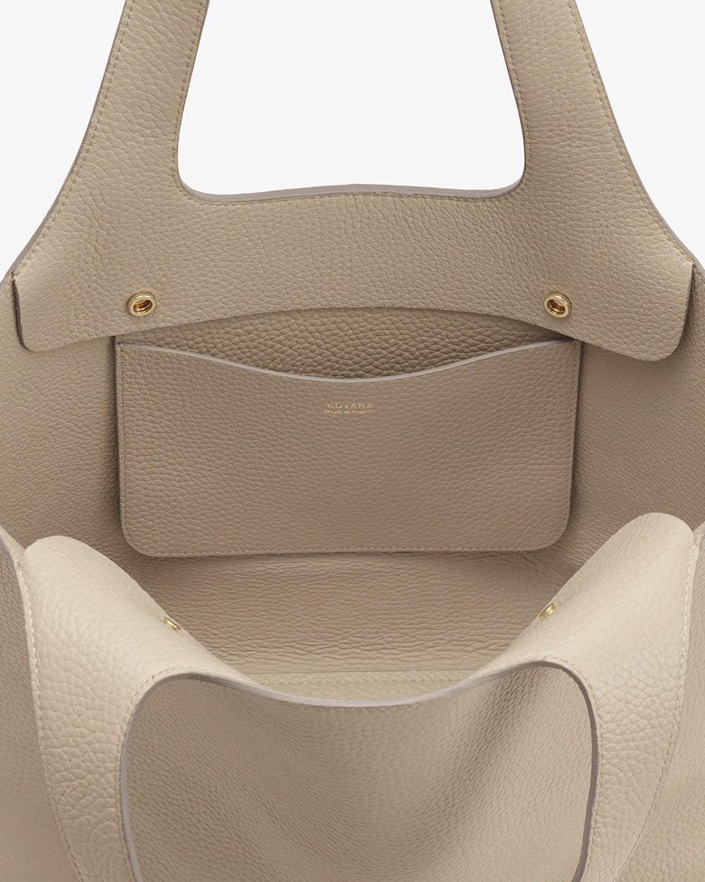 Open handbag with two handles and an exterior pocket.