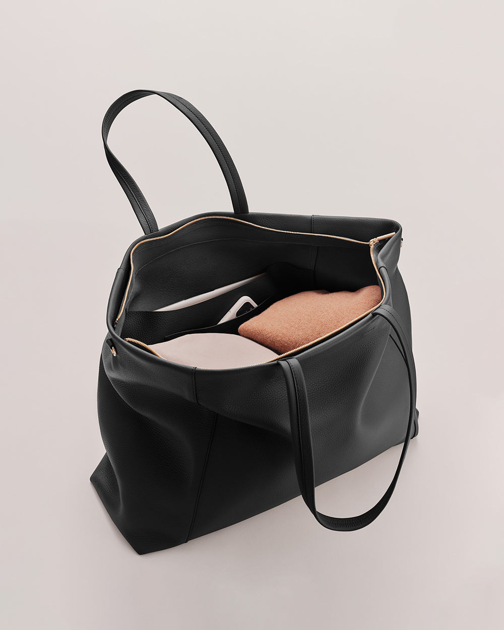 Open handbag with a book inside.