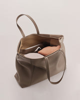 Open tote bag with a book inside.
