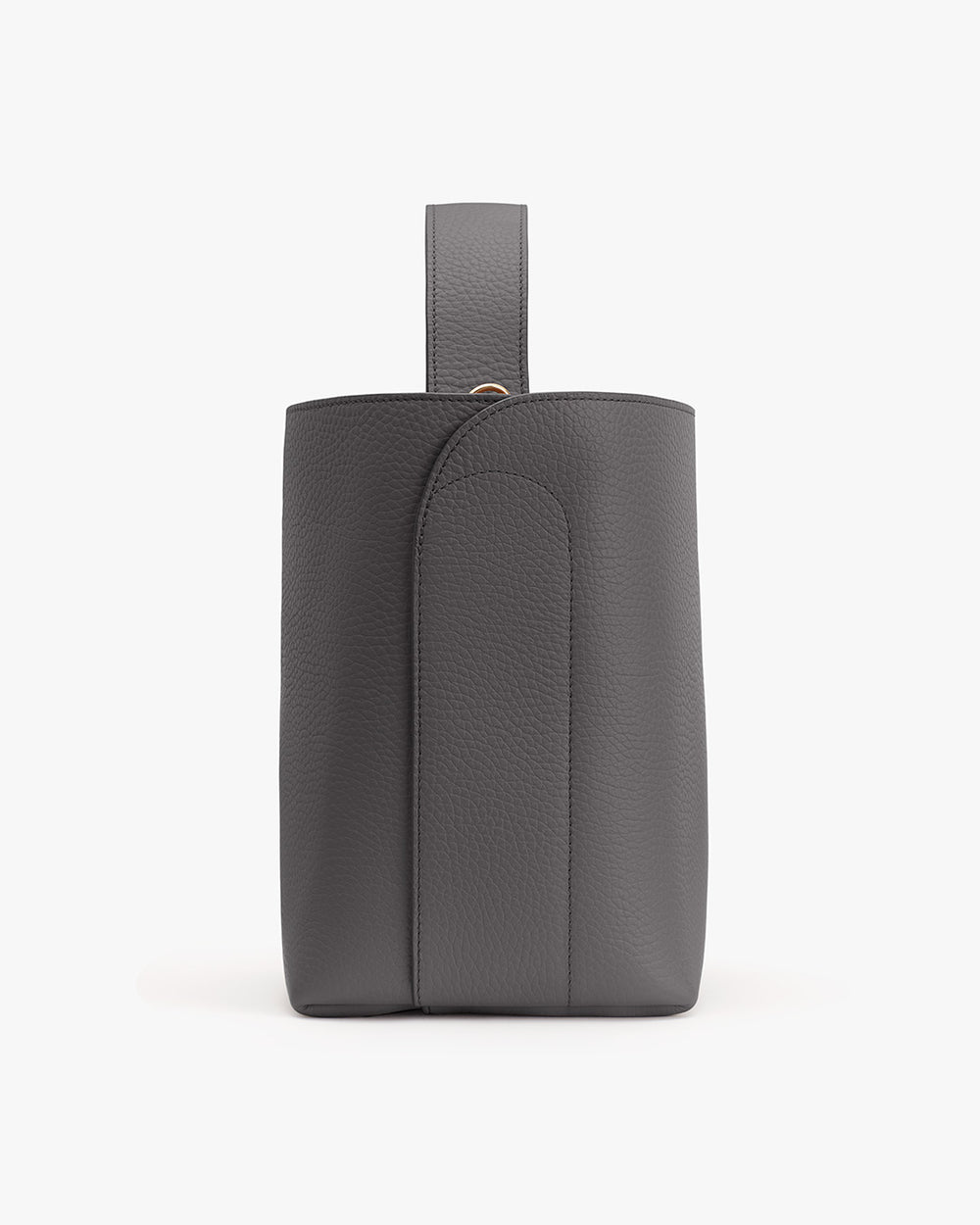Leather backpack with handle standing against a plain background.