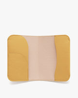 Open leather wallet with multiple pockets inside.